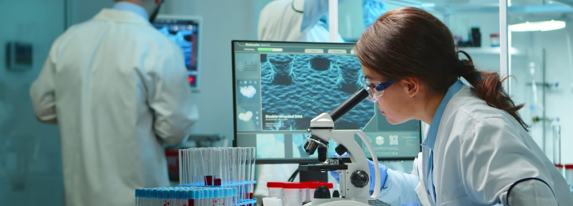 scientist-microscope-supplement-research Laboratory scientists reviewing samples and microscopy work, illustrating supplement research and development.